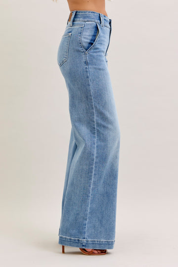 Light blue jeans worn by a person on a plain background