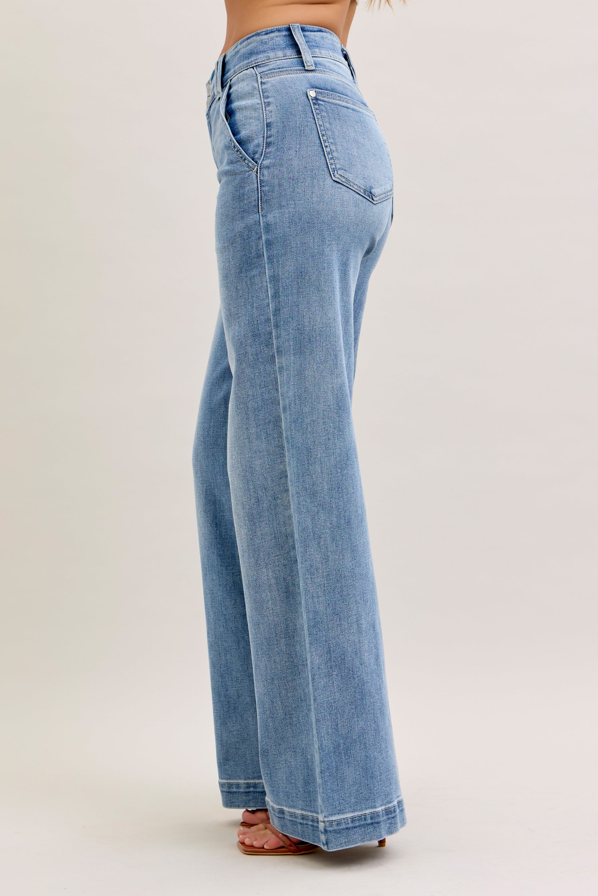 Light blue jeans worn by a person on a white background