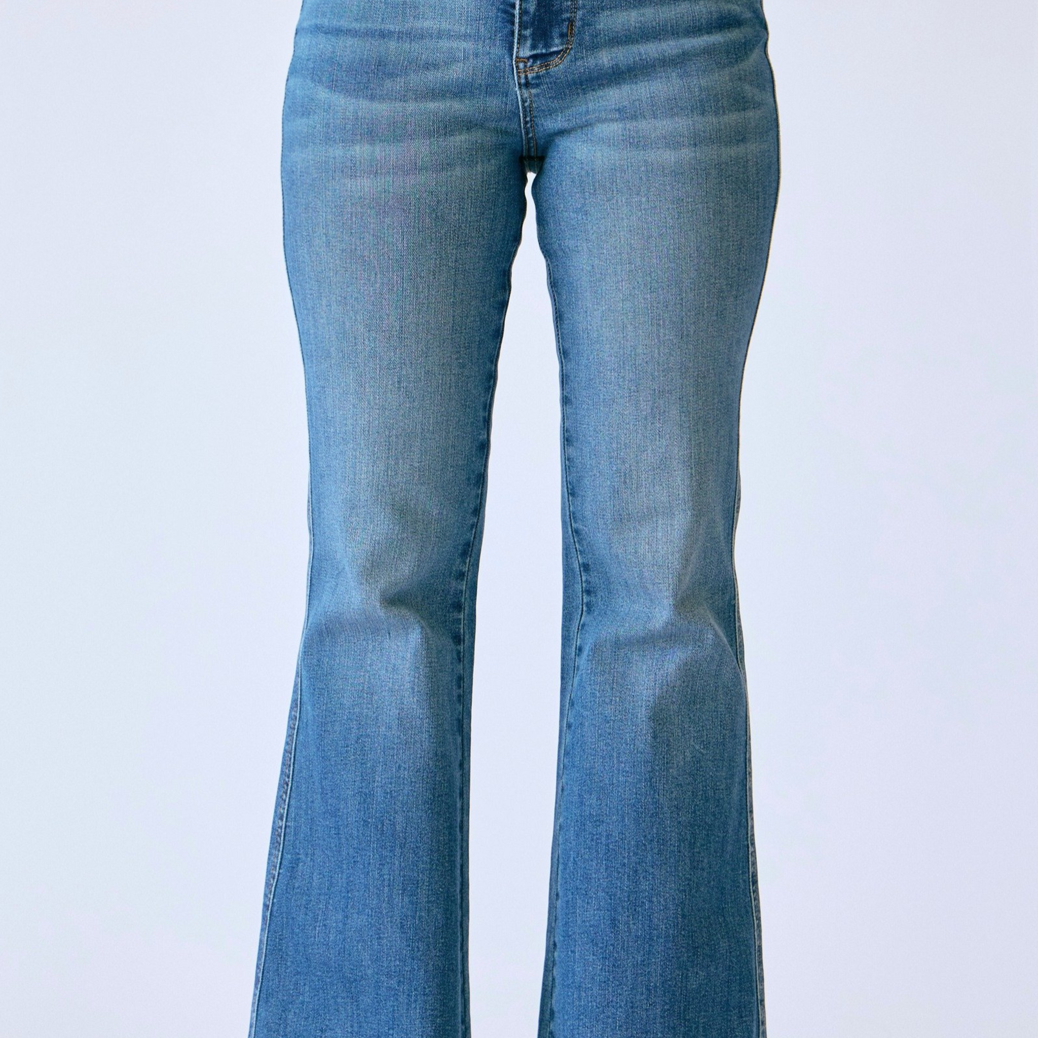 Blue flared jeans on a white background
