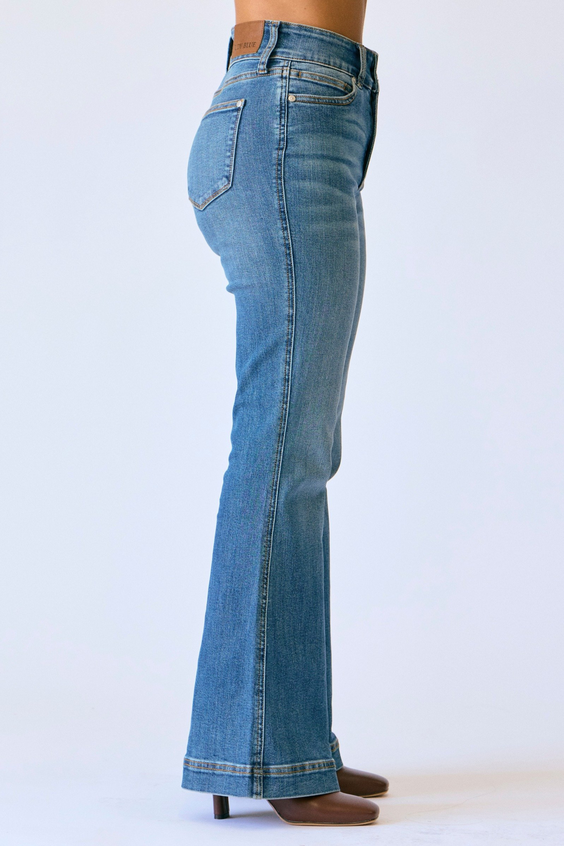 Blue flared jeans on a white background