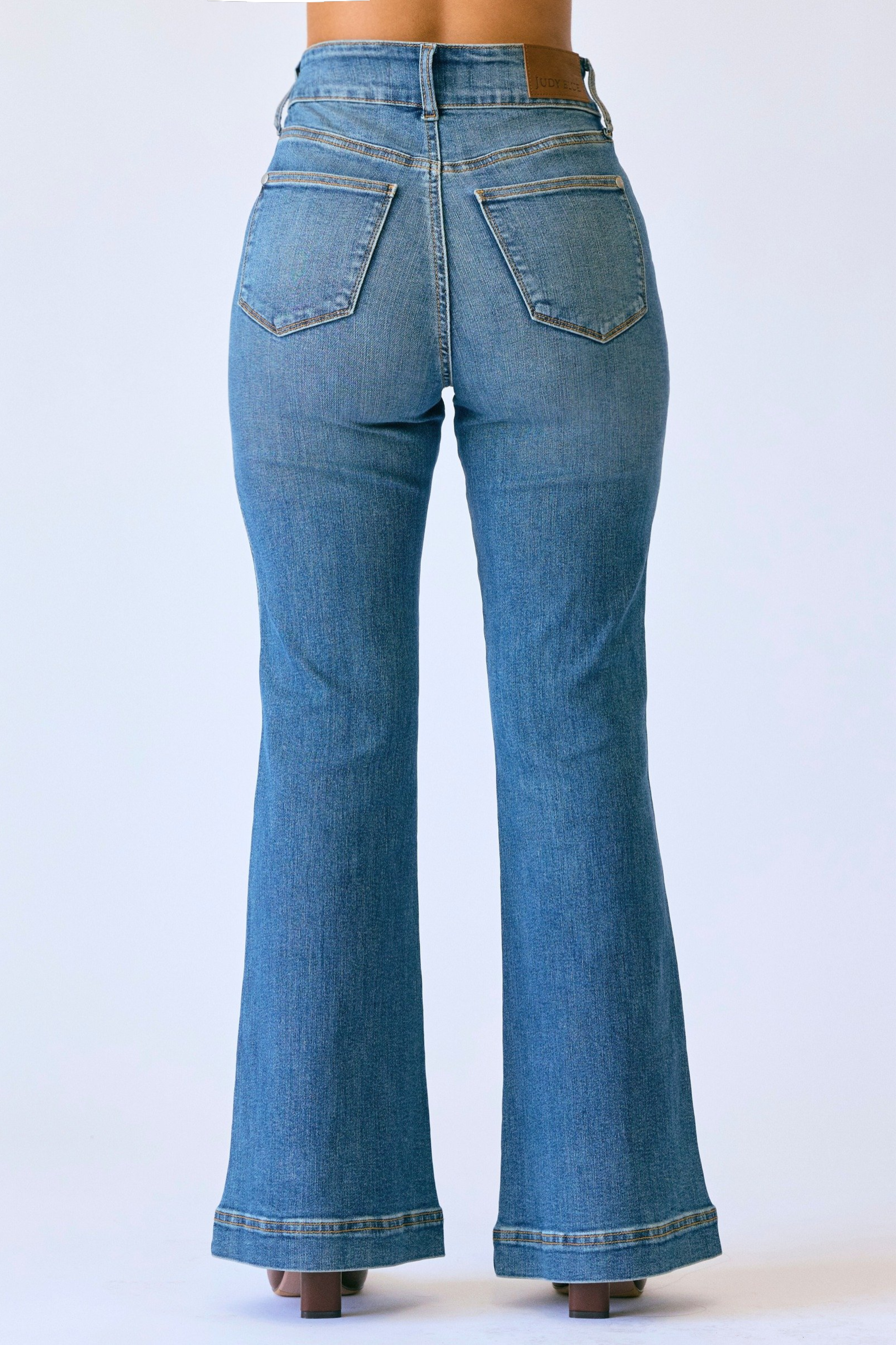 Blue jeans with a flared design on a white background