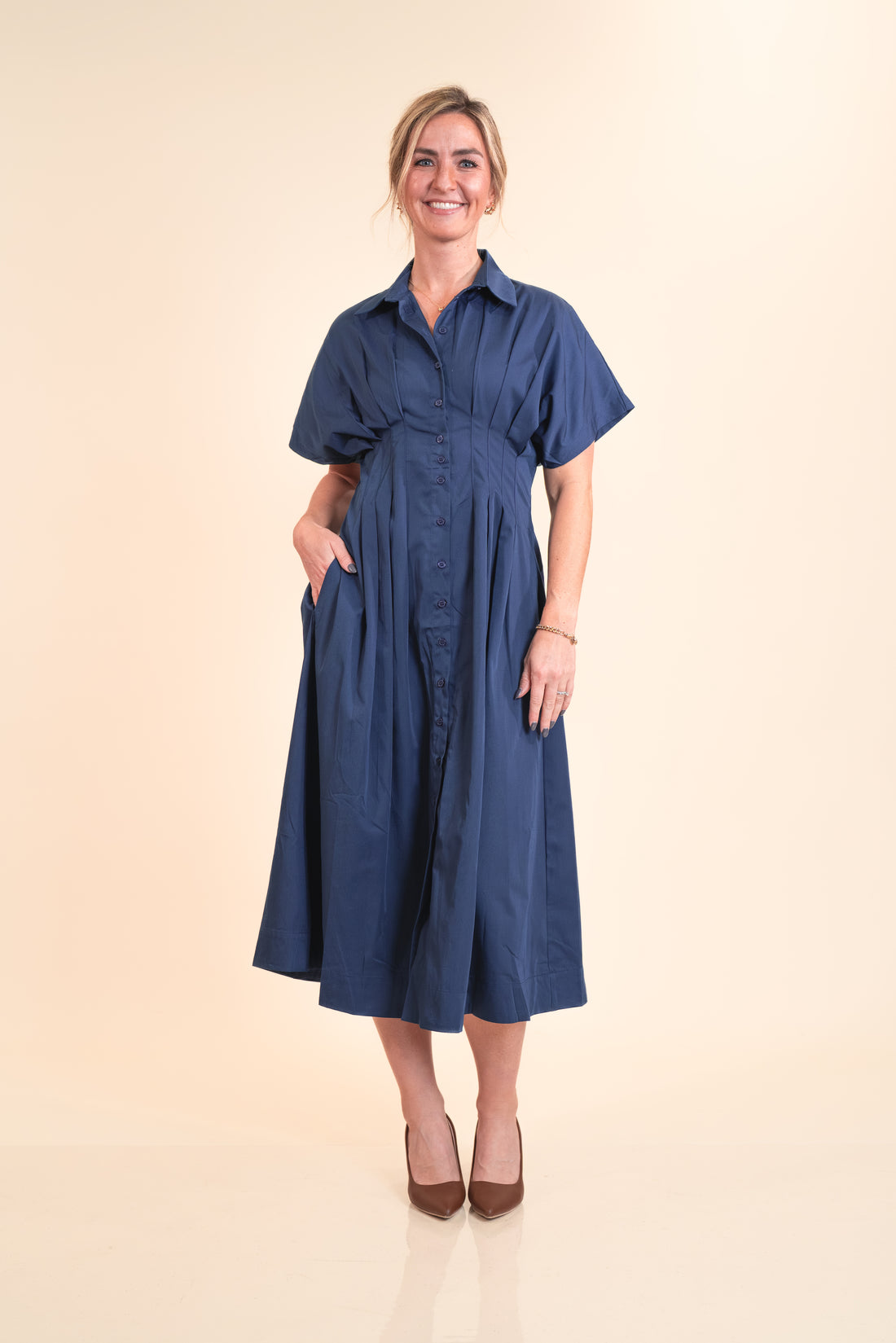 Woman wearing a blue dress on a beige background