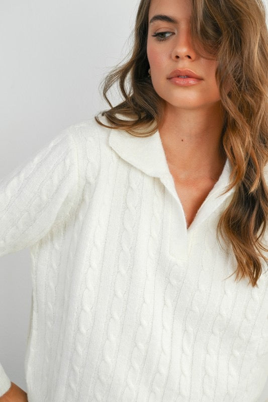 Woman wearing a white textured shirt against a plain background